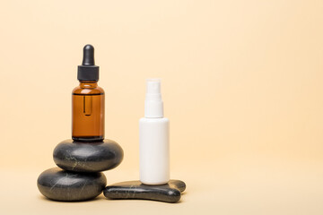 Plastic and glass cosmetic bottles on a beige background. Beauty concept.