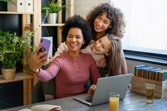 Loving african american foster care parent single mother embrace mixed race teen daughters