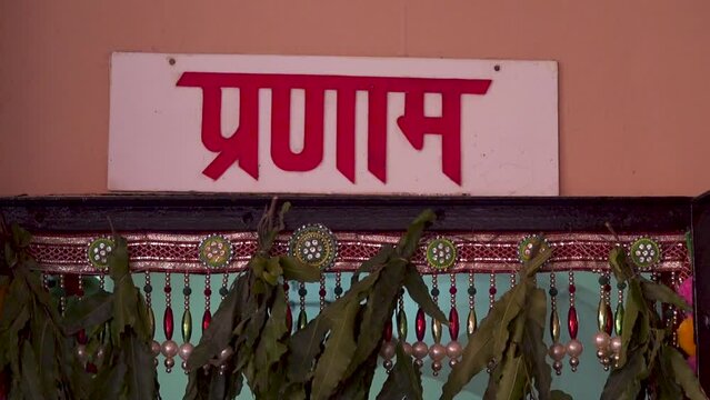 Welcome Greeting in Hindi on language on entry of typical house in India, Namaste Greeting sign bord at Indian house in rural or village. | Selective focus