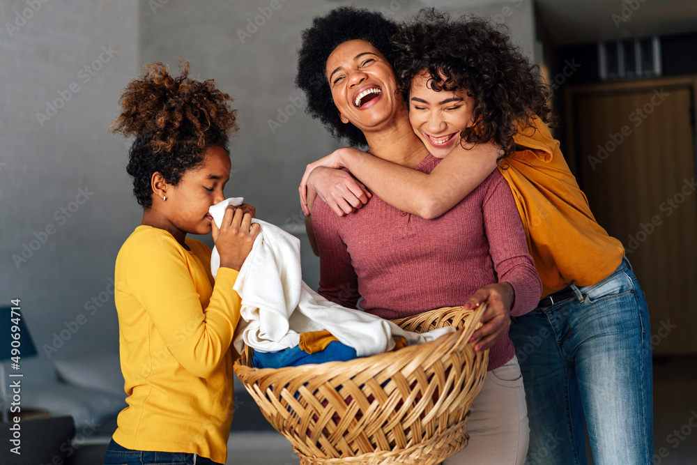 Wall mural happy black children helping for mother do household and domestic chores together