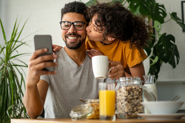 Happy couple having breakfast together in the kitchen