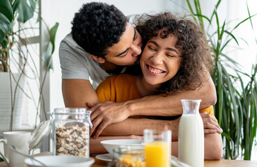 Portrait of happy smiling black couple in love having fun and hugging together