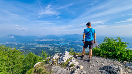 Man admiring the scenic view from summit of Ferlacher Spitze on Mittagskogel in the Karawanks,...