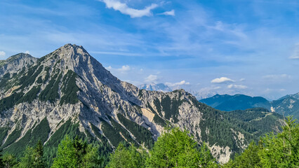 Scenic view from Ferlacher Spitze on summit mount Mittagskogel in the Karawanks in Carinthia, Austria. Borders between Austria, Slovenia, Italy. In back Julian Alps and the Triglav National Park.