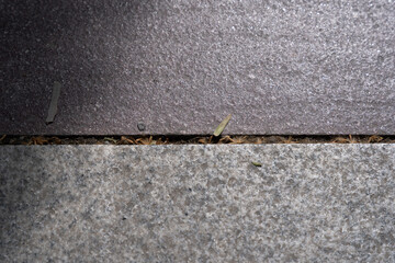 gray old concrete tiles on the street on a hot summer day, form interesting lines