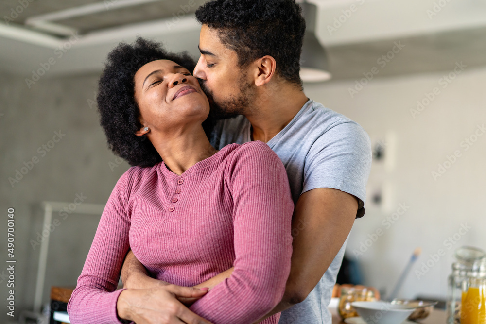 Wall mural Portrait of happy smiling black couple in love having fun and hugging together