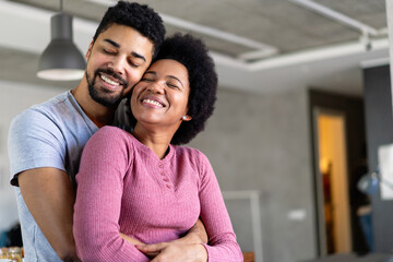 Fototapeta premium Portrait of happy smiling black couple in love having fun and hugging together
