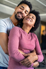 Obraz premium Portrait of happy smiling black couple in love having fun and hugging together