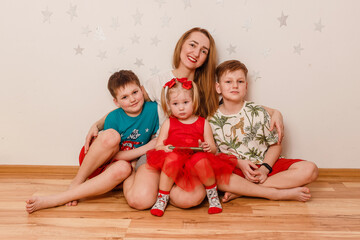 a woman hugs three children