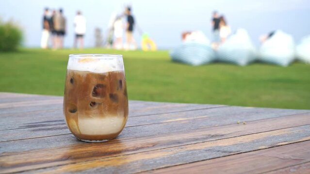 iced latte coffee glass on wood table