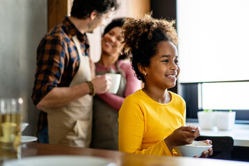 Happy multiethnic family in love together in kitchen. Parents child together concept