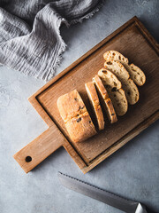 Bread on a cutting board isolated on a grey background