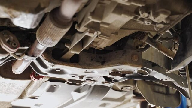 bottom view of the front suspension of the car, subframe, lever, drive, gearbox, fasteners.