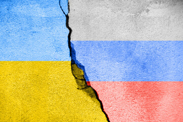 Cracked concrete wall with Ukraine and Russia flags