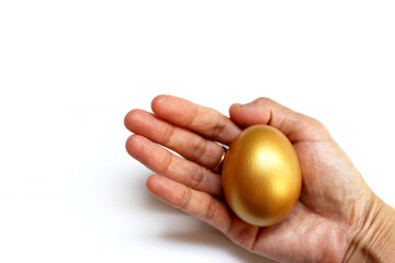 The golden eggs in hand isolated on the white background
