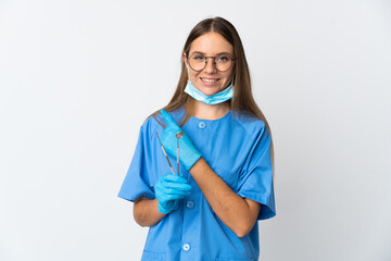 Lithuanian woman dentist holding tools over isolated background pointing to the side to present a...