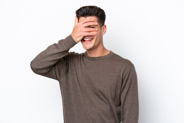 Fototapeta premium Young handsome caucasian man isolated on white bakcground covering eyes by hands and smiling