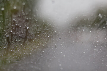 Close-up of water droplets on the windshield of a moving car