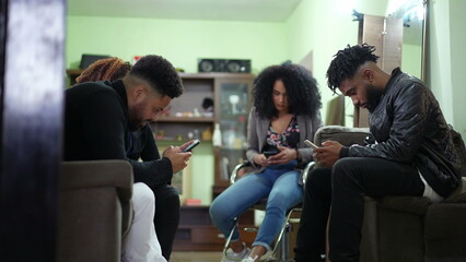 People hanging out staring at phones each person in their own technology bubble