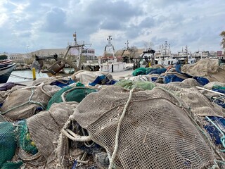 Parts of the old fishing net on the old abandoned boat