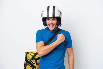 Young caucasian man with thermal backpack isolated on white background celebrating a victory