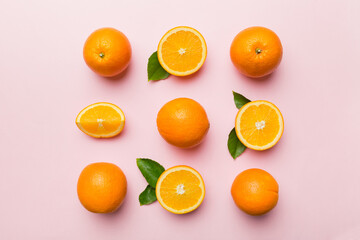 Fruit pattern of fresh orange slices on colored background. Top view. Copy Space. creative summer concept. Half of citrus in minimal flat lay