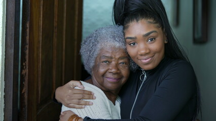 Grand daughter embracing senior grandmother authentic family love and embrace