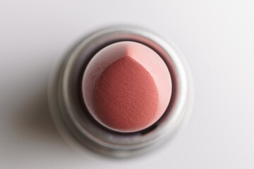 Macro shot of lipstick bullet, overhead view.