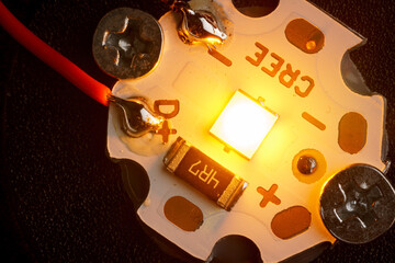 Led chip macro shot, glowing light emitting diode close up.