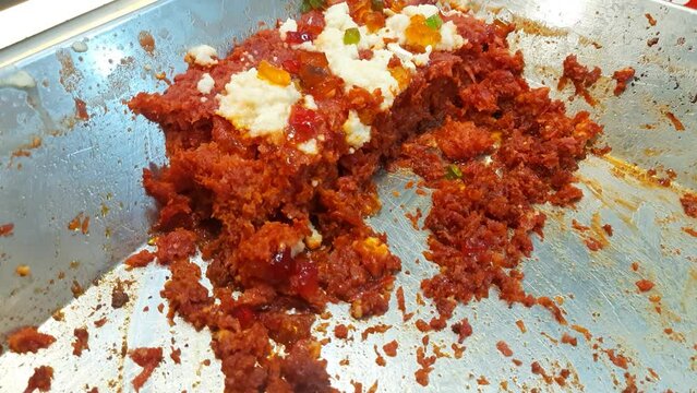 Gajar ka halwa is a carrot based sweet dessert pudding from India. Garnished with Cashew almond nut and jelly. Indian sweet food gajar ka halwa cooking in the pan in the kitchen - Carrot Halwa