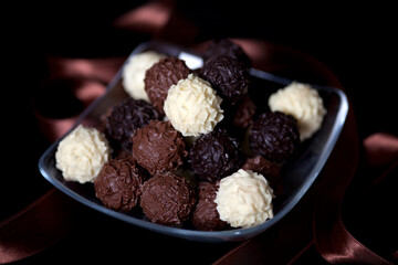 Chocolate candy balls with crunchy filling isolated on dark background