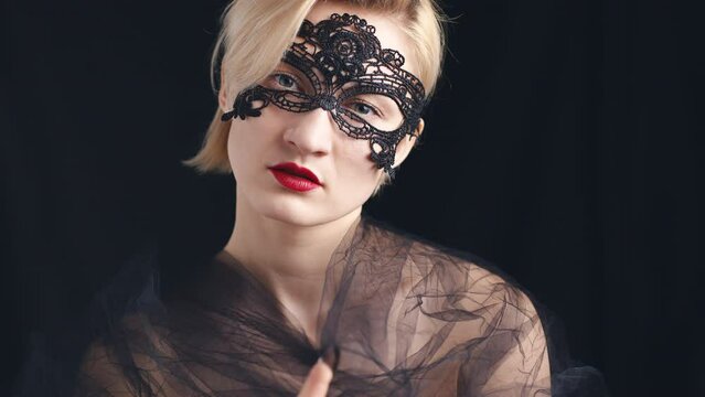 Portrait Of A Young Woman In Black Lace Mask And Veil. Blode short hair girl isolated on black