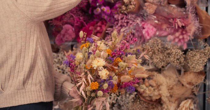 Female Florist Collecting Different Dried Flowers In Bouquet. Close Up