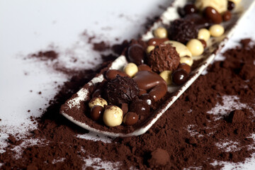on plate with chocolate dragees and cocoa