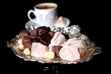 coffee and Turkish delight on black background