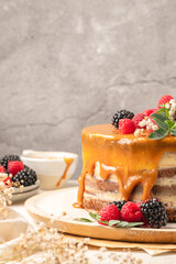 Delicious chocolate cake topped with mascarpone cream and salted caramel. Decorated with red...