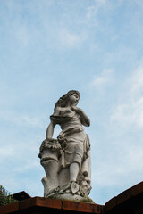 Statue of lady, with a blue sky behind her