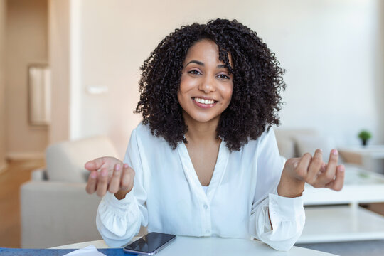 African-american elegant female entrepreneur discussing while having a conference call Portrait of confident ethnicity female employee looking at camera talking on video call in the home office.