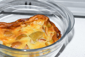 Apple pie in a transparent bowl in the microwave, oven