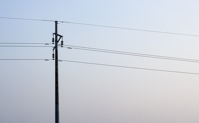 Electricity transmission pole in the urban area with copy space
