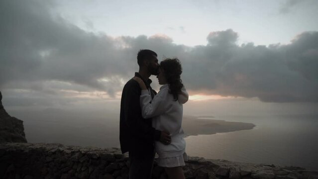 Young couples silhouette and the storm landscape sunset