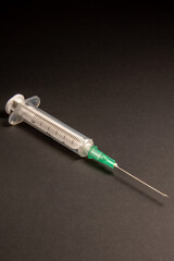 A medical syringe with a needle.