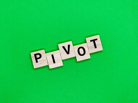 Alphabet with the concept of the word Pivot on a green background.