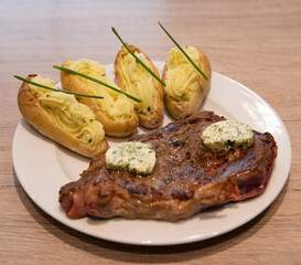 Sauteed sirloin beef recipe, maitre d'hotel butter and Arly potatoes. High quality photo