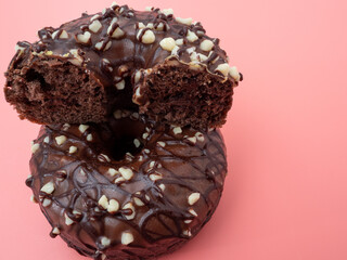 Fresh chocolate donut on a pink background. Chocolate donut