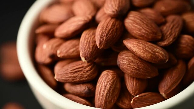 almonds in blow rotate,close up bean almond black isolated rotate