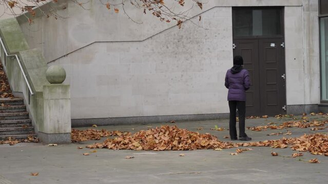 Woman Play Racquetball Alone In Autumn Street.