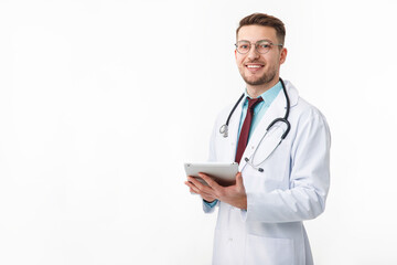 Portrait of confident young medical doctor on white background. Holding a tablet in his hands