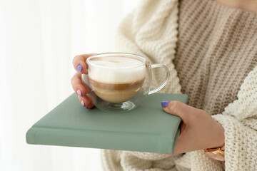 woman with a cup of hot drink