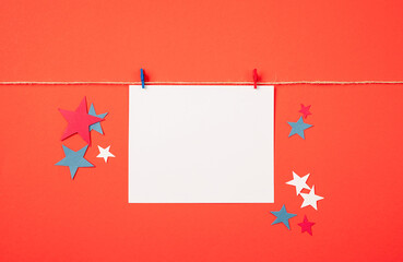 Blank white paper for mockup design with red and blue clips on red background